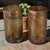 This product is a pair of hand-blown attributed Murano art glass tumblers in a copper and gold color. The contemporary...