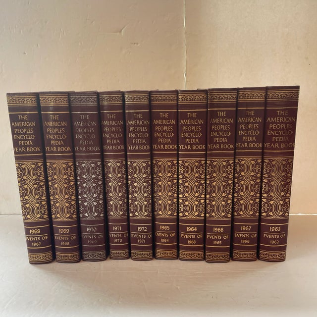 Set of 10 leather bound books rich dark reddish burgundy, beautiful gilt titles and decorative embellishments, with...
