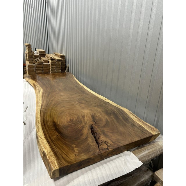 One tree. One top. One of one. A true single-slab live edge table: one continuous cross-section of a single Saman tree...