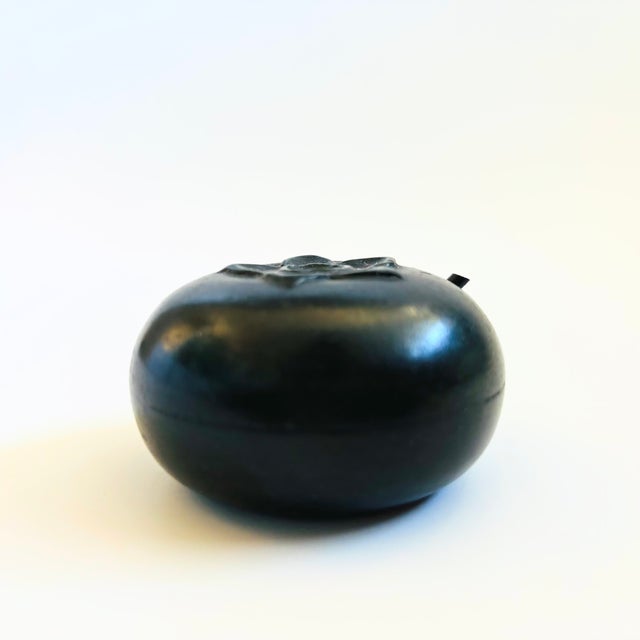 A vintage cast iron Japanese suiteki water dropper in the shape of a persimmon. Traditionally used for calligraphy or ink...
