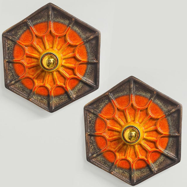 An exceptional set of Orange/Braun Ceramic wall lights. Manufactured in Germany in the 1970s. The set shows a playful...