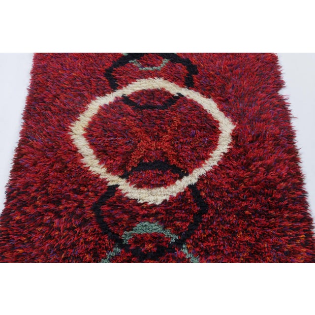 Hand-knotted in lush, high-pile wool in Sweden circa 1960-1970, this 3x5 vintage Swedish Rya rug is a bold new addition to...