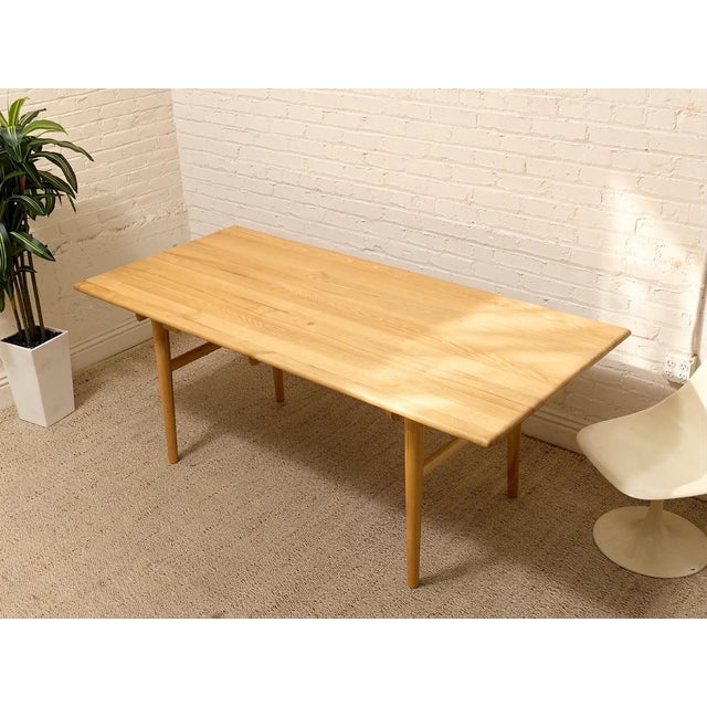 A beautifully understated dining table inspired by the timeless Danish modern designs of Hans Wegner. Crafted in warm oak,...