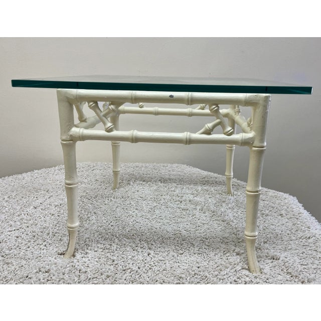 Vintage chinoiserie table made of wrought iron with a thick glass top (0.5 inch). The legs are tapered and flared at the...