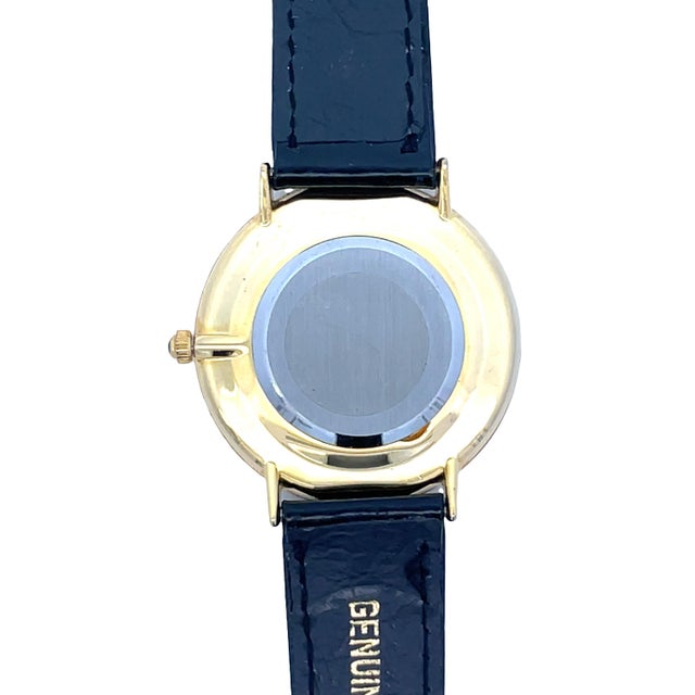 Vintage Moulin quartz wristwatch featuring a colorful gemstone-studded peacock dial set in a gold-finish stainless steel...