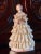 Vintage Lee Wollard porcelain figurine of a young woman wearing an off-white lace dress over a light pink bodice holding a...