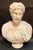 A graceful Italian marble bust depicting the Roman emperor Marcus Aurelius, finely carved in luminous Carrara white marble...