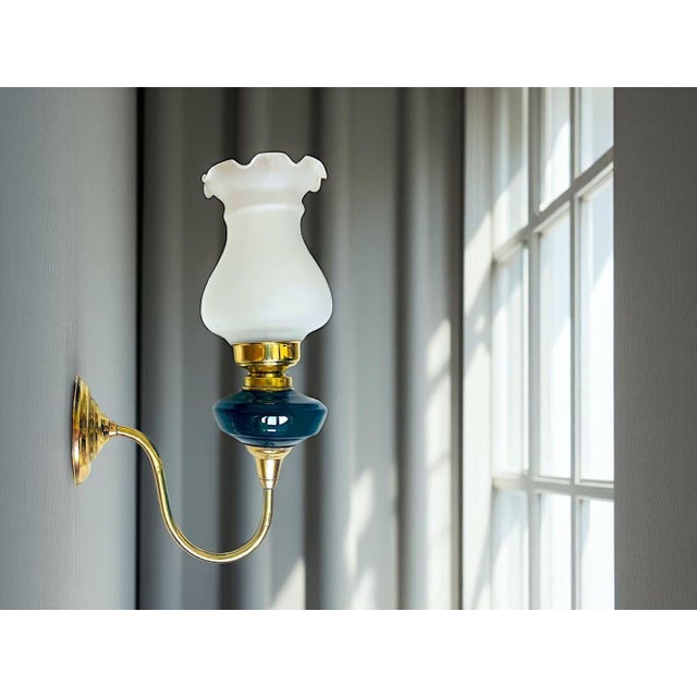 This mid-century wall sconce in the style of Art Nouveau was made of brass, with green glass detail and topped with a...