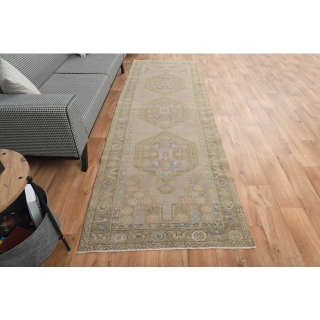 Vintage Hand-Knotted runner rug is a semi-antique vintage area rug. The '70s Eastern region of Anatolia's unique rug is...