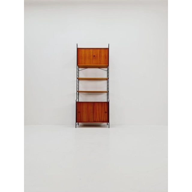 String shelf system, bookcase with cabinet teak by WHB Germany, 1950s The bookshelf system is in great vintage condition....