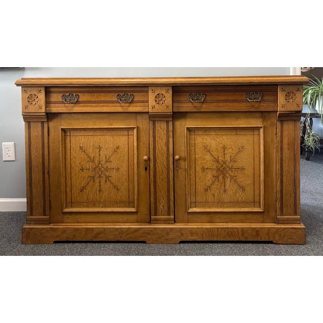 This 19th century English oak sideboard is a beautifully crafted example of traditional country furniture, blending...
