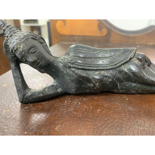 This beautiful vintage reclining Buddha bronze sculpture depicts the Buddha in a serene resting pose, symbolizing peace,...