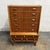 A distinctive Danish high chest dating to the 1940s, with a mix of teak and oak tones, tall case form, and a highly...