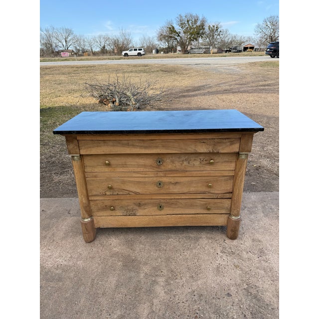 19th Century French Empire Commode from France. Made of solid walnut, with a black marble top, the wood was professionally...