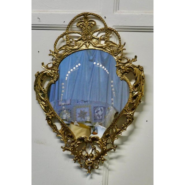 Unusual brass filigree mirror with etched glass pattern A very attractive piece with an unusual shape and decorative brass...