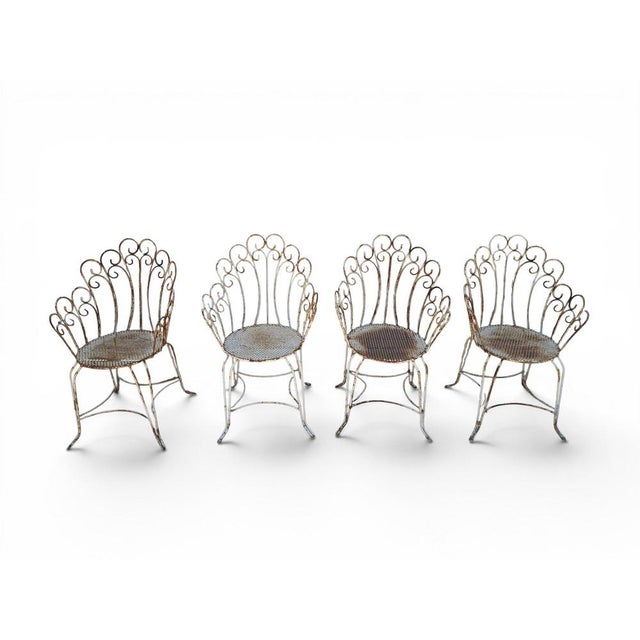 Charming set of four garden chairs crafted in painted iron during the 1950s. Combining durability with elegant mid-century...