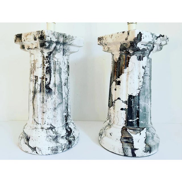 Magnificent big marbled glazed porcelain Doric column lamps in rich shades of black and white with realistic veining....