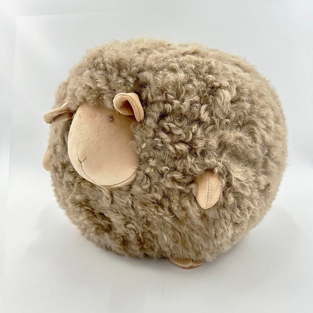Beyond its irresistibly cuddly charm! This beige plush sheep adds a touch of whimsy to any space—perfect for a nursery, a...