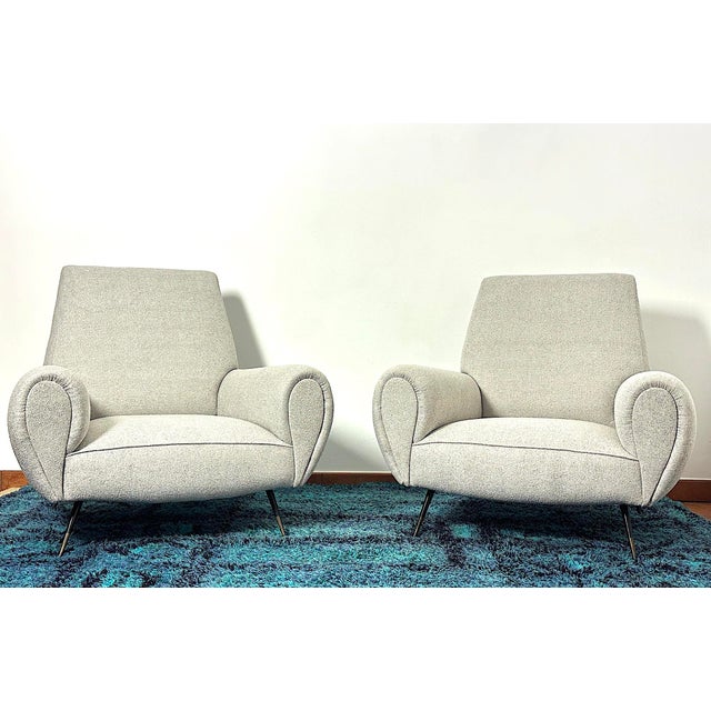 An extraordinary pair of 1950s armchairs by designer gigi radice, an icon of mid-century design. This pair perfectly...