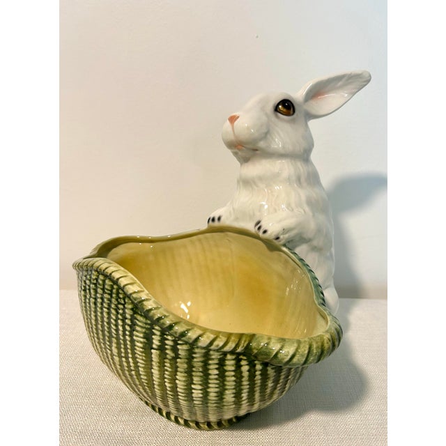Charming Italian porcelain rabbit figurine featuring a beautifully detailed wicker-style basketweave bowl. Imported by...