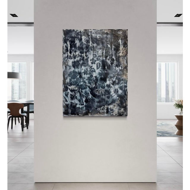 This moody mixed-media painting blends oil and encaustic to create a soft, ghostly floral impression that feels both...