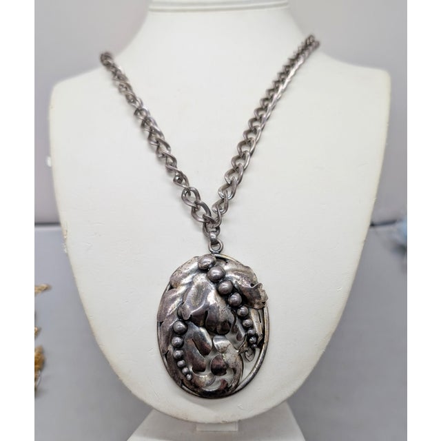 1950s silvertone oval stylized leaves with bumps pendant on a chunky chain with spring ring clasp necklace. Marked...