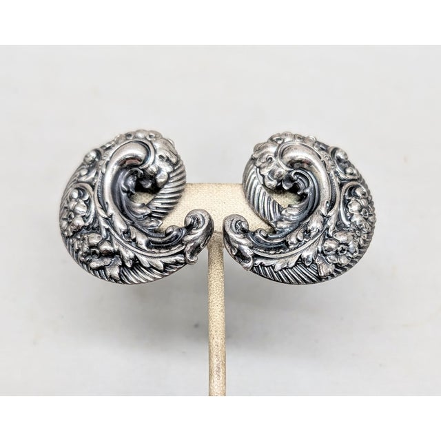 1950s big silvertone repoussé floral design swirl clip earrings. Marked "NAPIER PAT. PEND" on the clips and at the bases...