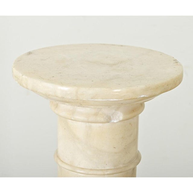Dimensions: 39 ¾” H x 12” W x 12” D A dazzling early 20th century French hand-carved natural alabaster pedestal, that...