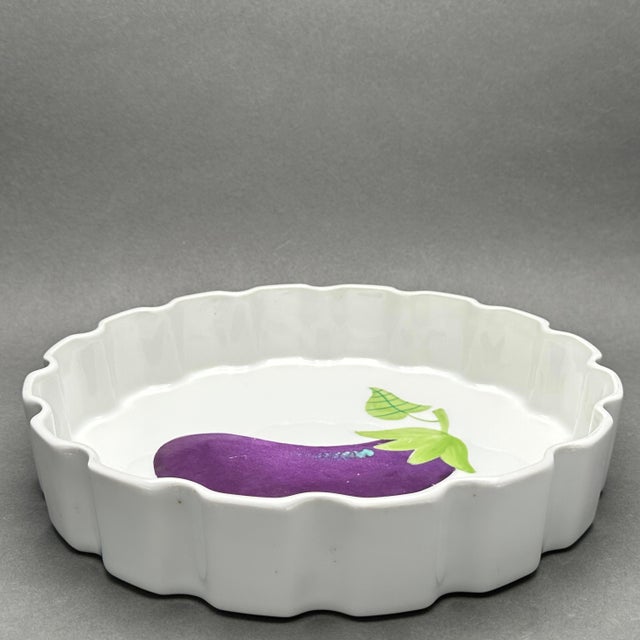 • This elegant vintage porcelain tart or quiche dish features a vibrant hand-painted eggplant (aubergine) design in the...