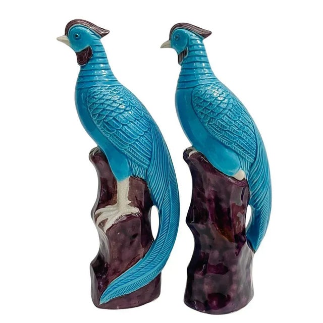 Pair of early 20th century Chinese porcelain phoenix birds decorated with a high glaze turquoise, purple / eggplant and...