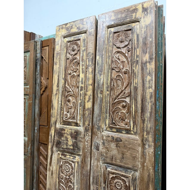 Bring timeless character and artisanal craftsmanship into your home with this stunning pair of vintage hand-carved closet...