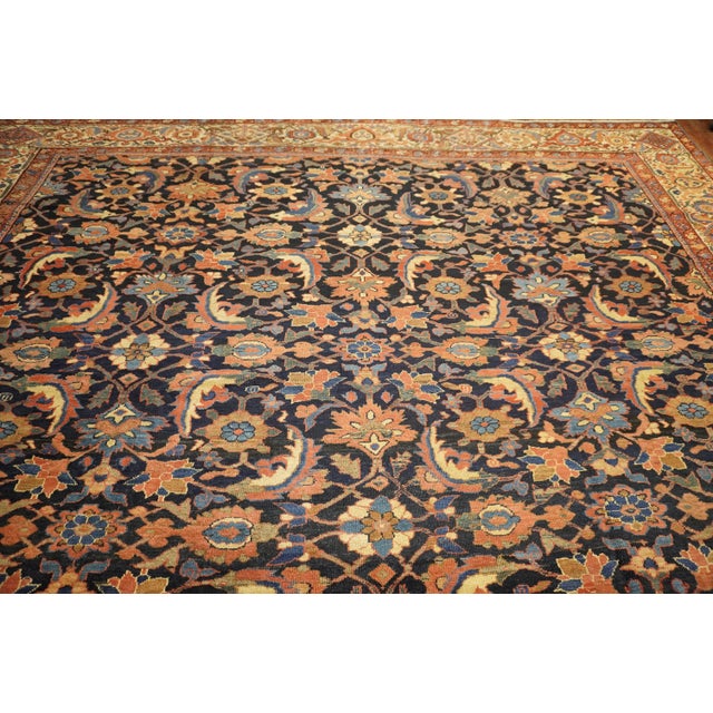 An early 20th century high decorative connoisseur caliber Persian Mahal Sultanabad rug with an all-over navy field and...