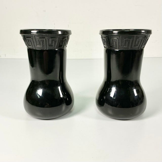 A lovely pair of 1950s Black Amethyst onyx Vases. They feature a tulip-bulb base and flare out at the top rim. Around the...