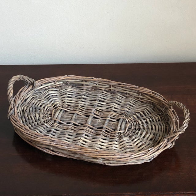Offering a small handmade wicker tray from the early 20th century. This rustic antique tray is perfect for displays or use...