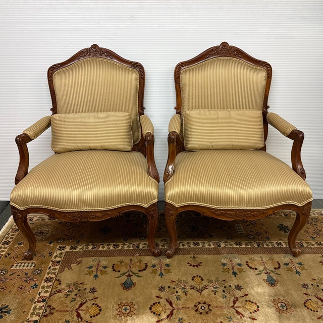 Design Plus Gallery presents a Pair of Throne Chairs with Louis XV Styling. The chairs have cabriole legs with wide seat...