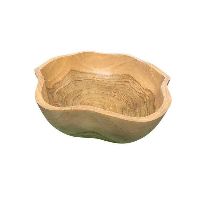 This teak live edge bowl is a unique piece showcasing the natural beauty of teak wood. Crafted by skilled artisans, its...