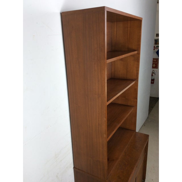 This mid century modern shelving unit by Basic-Witz features hardwood construction, walnut veneer with original finish,...