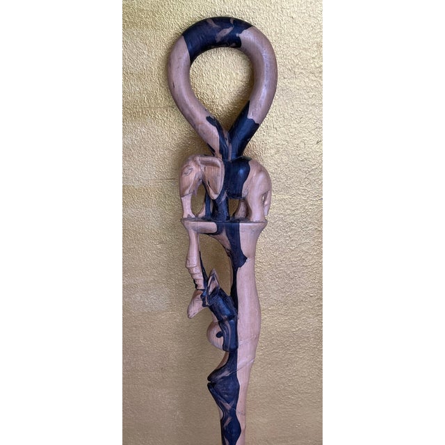 This artfully crafted walking stick impresses with its unique design made of contrasting ebony. The handle is formed into...