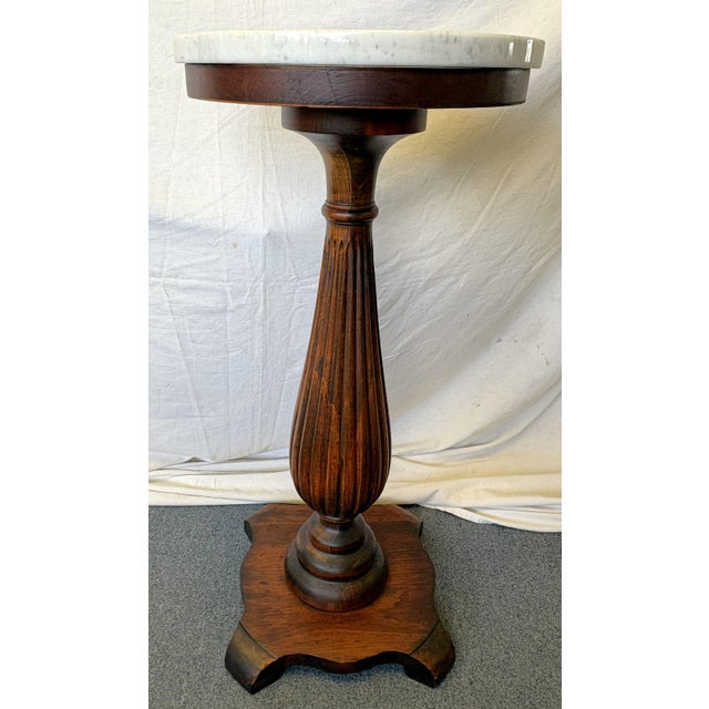 Timeless wood plant stand from the early 1900's. It is hand made of solid wood with a reeded column and 7/8" thick white...