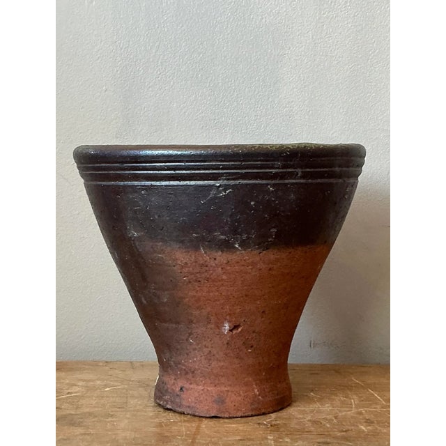 This compelling vintage studio pottery vessel showcases the raw, tactile beauty of handcrafted stoneware characteristic of...