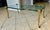 1970s Hollywood Regency cocktail coffee table featuring a thick serpentine shaped glass top supported by four sculptural...