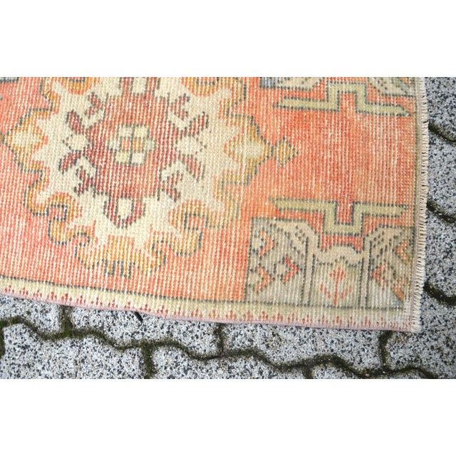 This is a vintage Turkish Oushak rug from the 1960s. The piece was hand-knotted.