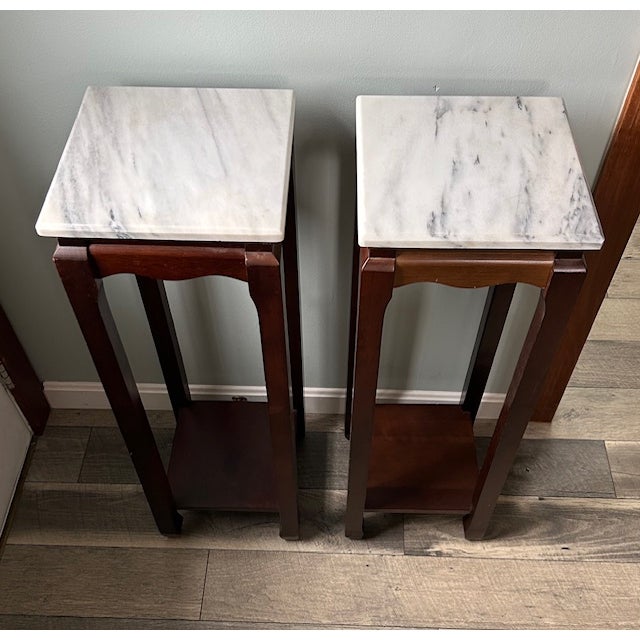 This pair of 12" square mahogany Asian-style plant stands is the perfect ornamental or plant display for any vacant space...