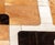 Cowhide Patchwork Carpet, with leather stitching in brown, black, and white. 9' 8" L x 6' 9" W. Provenance: From a 320...