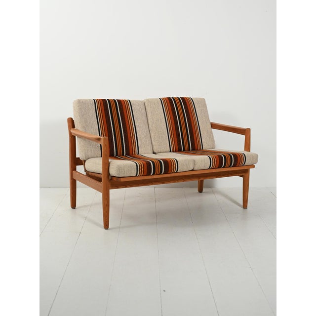Scandinavian pine sofa by Harry Moen for Bruksbo, with a slatted backrest and original striped wool cushions. Two-seater...