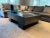 A sophisticated minimalist concrete coffee table in a natural dark gray finish with a smooth, geometric mid-century flair...