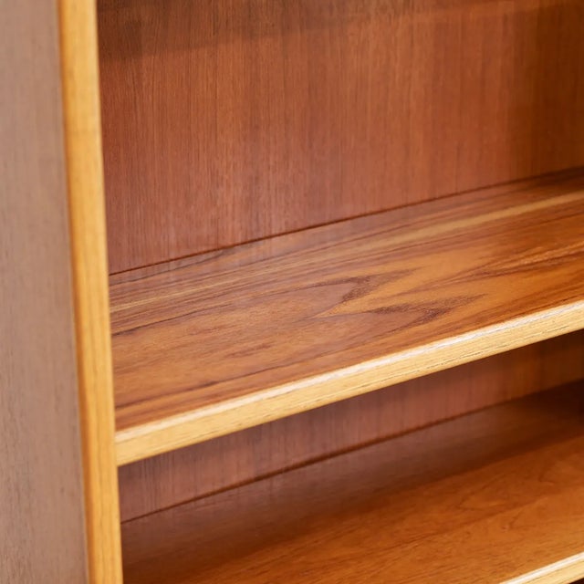 This vintage bookcase was produced in Denmark during the 1970s. A tall handsome bookcase, It is constructed of teak and...