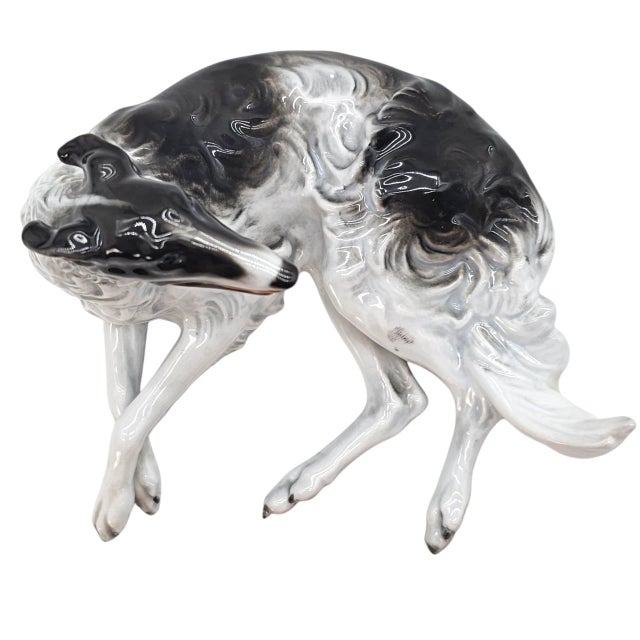 An embodiment of elegance, this reclining Borzoi captures the essence of sculptural poise and aristocratic calm. Crafted...