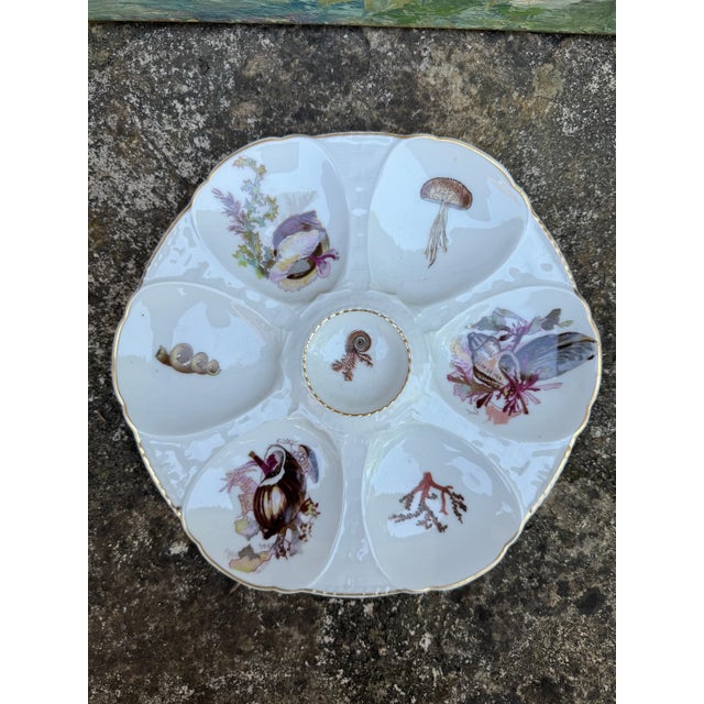 French oyster plate with gold rim. Makers mark on underside. 10”dia 49-019