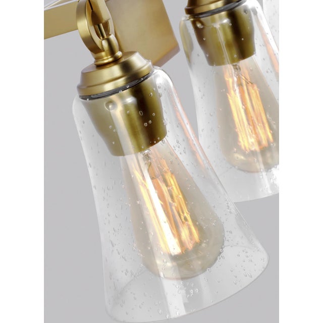 The Sean Lavin Monterro three light vanity fixture in burnished brass offers shadow-free lighting in your powder room,...